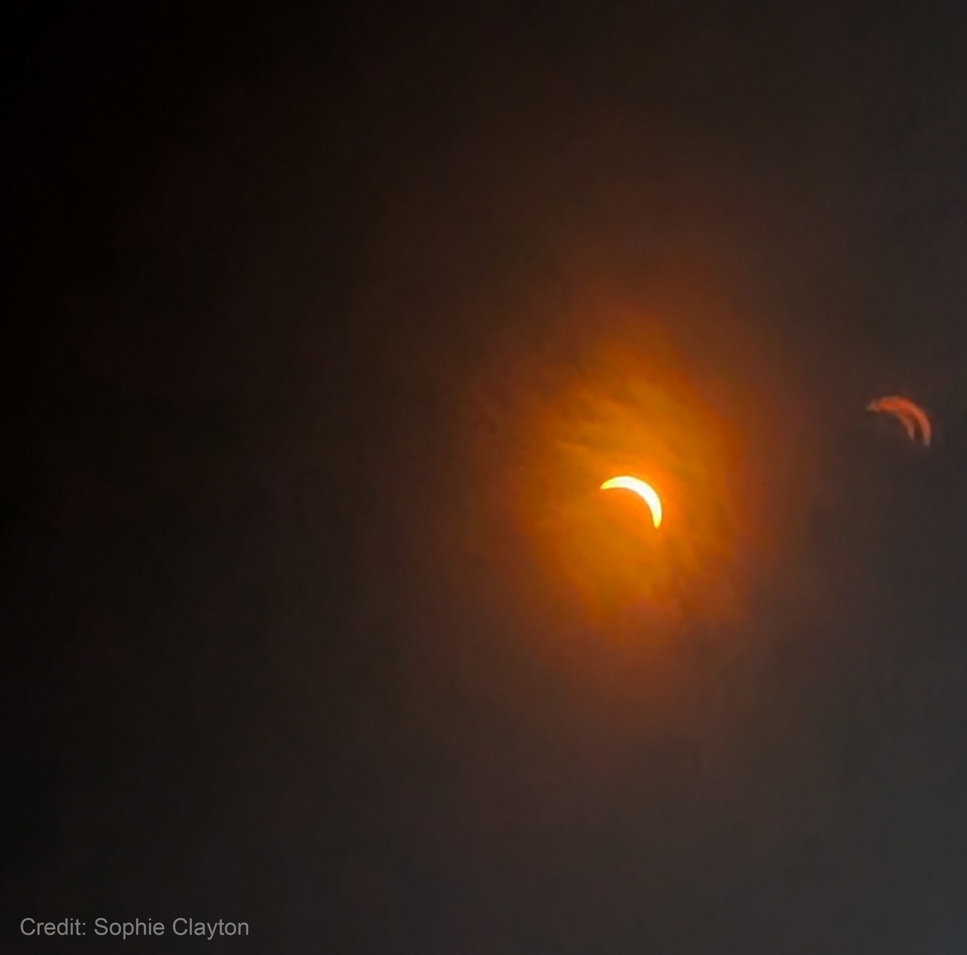 A solar eclipse of about 80 percent, making the sun look like a crescent moon.